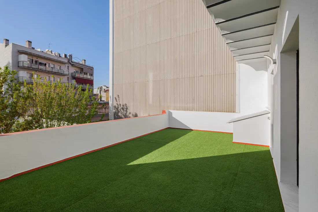 Artificial turf laid in a small paved courtyard
