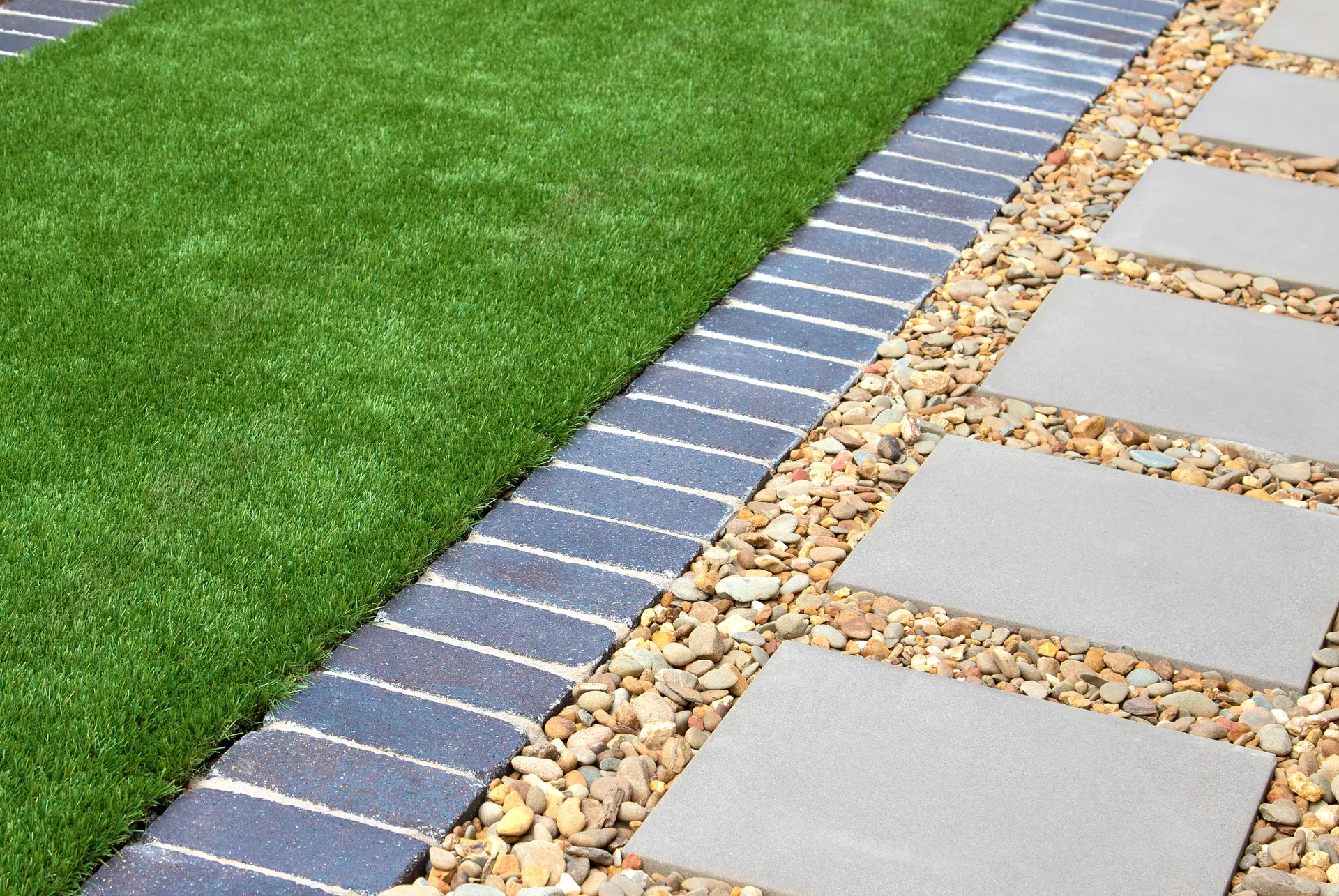 A landscaped Australian backyard with freshly laid artificial turf