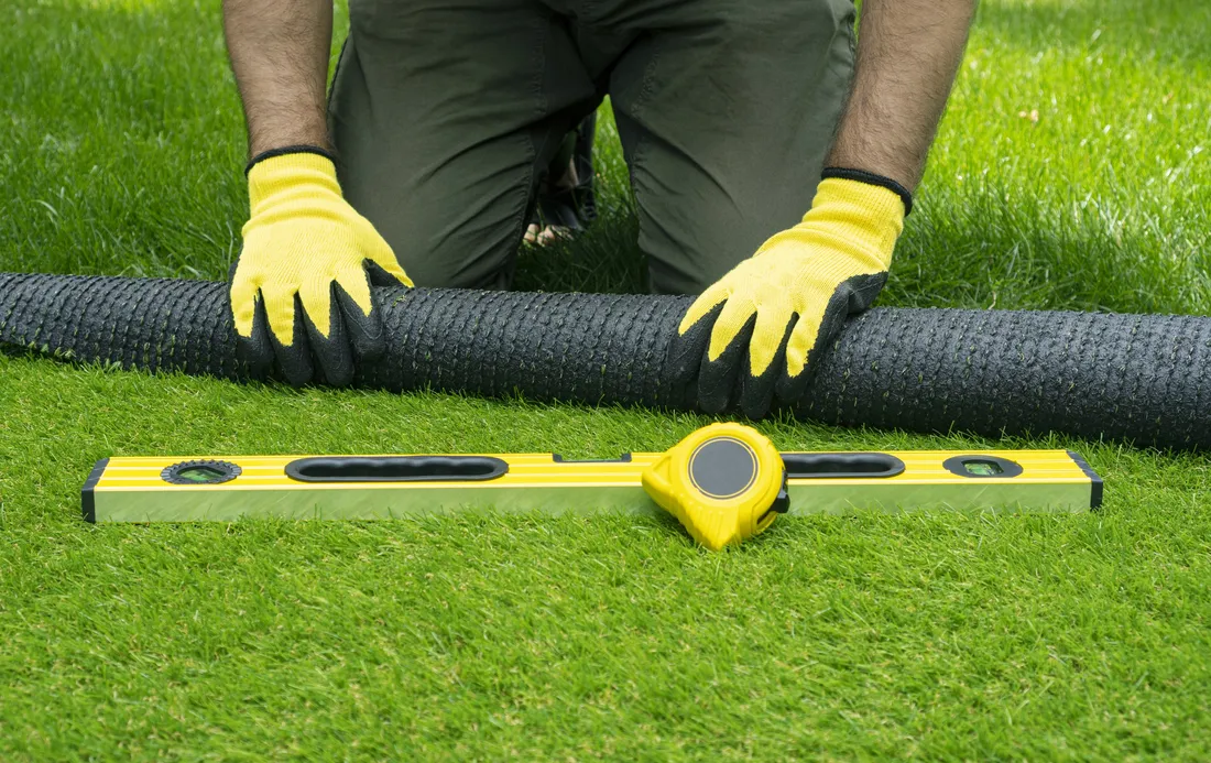 Installer measuring out a small rectangular lawn area