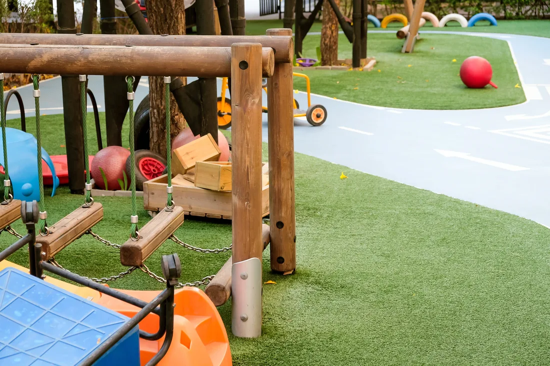 Play equipment on synthetic turf at a childcare playground
