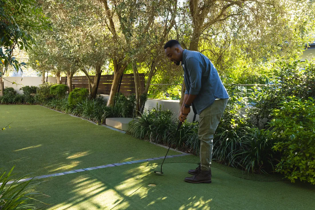 A backyard putting green built from short-pile artificial turf